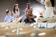 © pressmaster - Three young people with papers listening to their stage performance coach during lesson of eloquence
