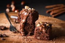 Chocolate Cake Brownie Squares With Chocolate Glaze And Walnuts. Closeup View, Selective Focus