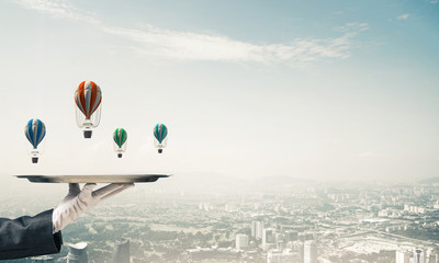 Wall Mural - Hand of waitress presenting balloons on tray.
