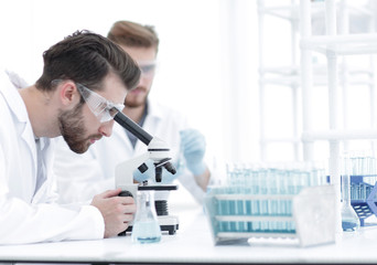 Wall Mural - biologist explores the substance under the microscope
