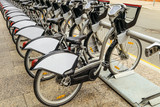 Fototapeta  - Row of rental bicycles in city