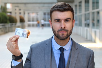 Wall Mural - Serious man with dollar bill on fire 