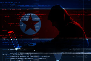 hacker using laptop on dark background