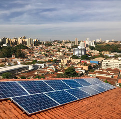 photovoltaic power plant on the roof of a residential building on sunny day - solar energy concept o