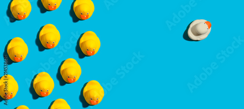 Photo: One out unique rubber duck concept on a blue background One out unique rubber duck concept on a blue background