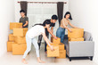 © Art_Photo - Group of friends holding box and moving into their new home.House moving and real estate concept