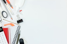 Notebooks, Calculator, Glue And Other Office Supplies On White Table Background