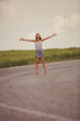 © astrosystem - Girl enjoying on a empty suburb road.
