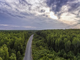 Fototapeta Na ścianę - Aerial view of old asphalt road through wild forest