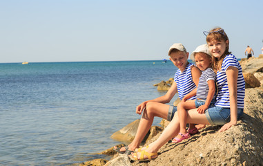 Wall Mural - Three children on the beach