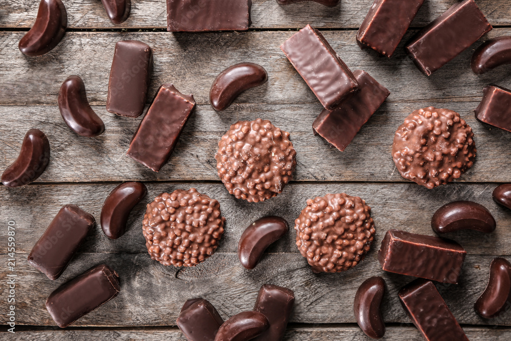Delicious chocolate candies on wooden table