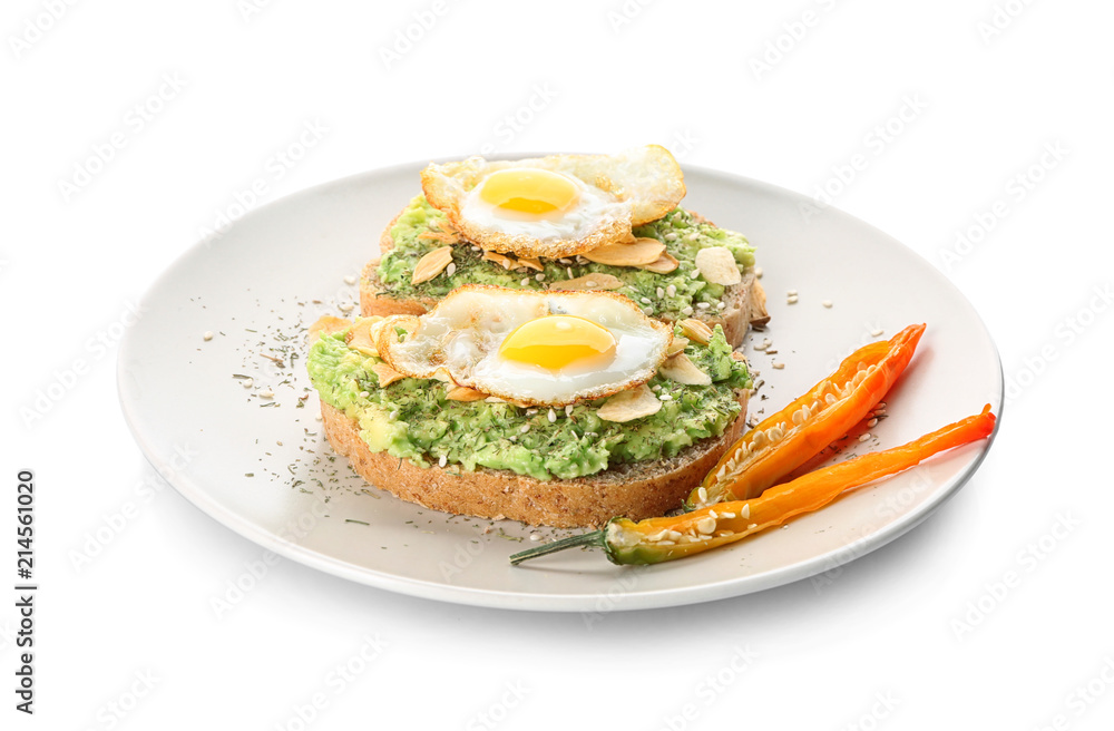 Delicious toasts with avocado and eggs on plate, isolated on white
