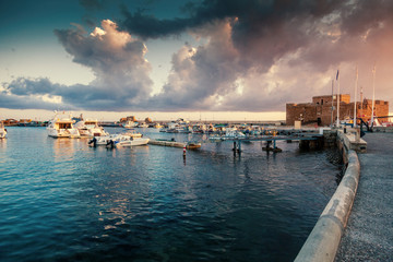 Wall Mural - Beautiful colorful sunset in the port with boats, Paphos, view of the castle of Cyprus, beautiful landscape