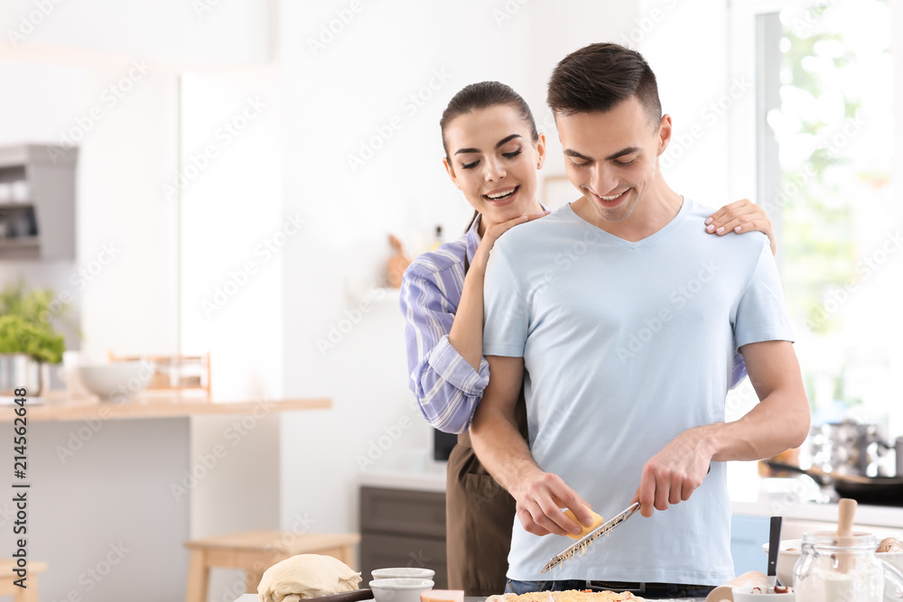 Young couple cooking together in kitchen