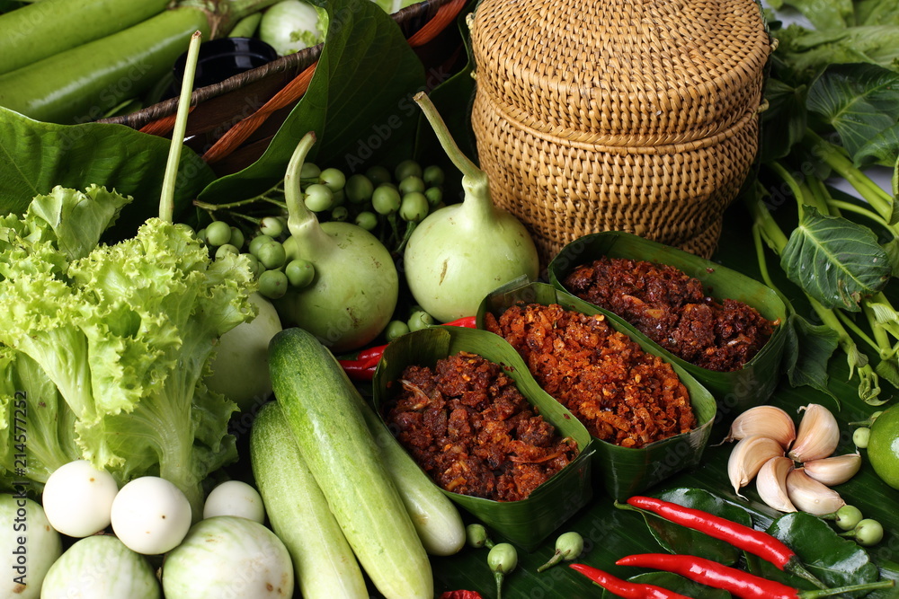 Famous Thai Food Hot and Spicy sauce with local ingredient fresh herb, paste sauce and vegetable arrange set , South East Asia style healthy food low price Top view on banana leaf - obrazy, fototapety, plakaty 