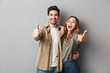 © Drobot Dean - Happy young couple showing thumbs up