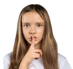 Portrait of attractive teenage girl with finger on lips