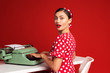 © fotofabrika - pin up girl typing on a typewriter