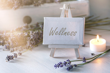 spa or wellness still life: little image with lot of lavender in front of vintage wooden furniture a