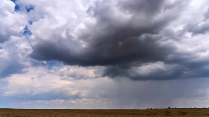 Wall Mural - Time lapse footage of approaching storm with heavy clouds on blue sky background.