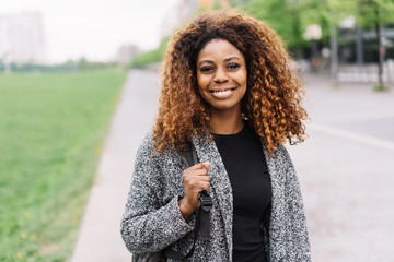 Street portrait of young black smiling woman