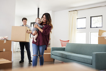 Wall Mural - Family With Baby Carrying Boxes Into New Home On Moving Day