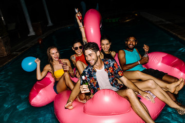 Wall Mural - Friends having evening pool party