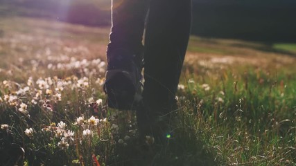 close up shot of woman legs hiking steep terrain on field, slow motion