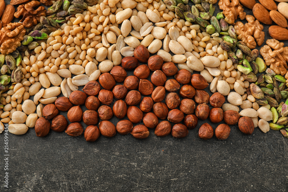 Composition with different nuts on grey background