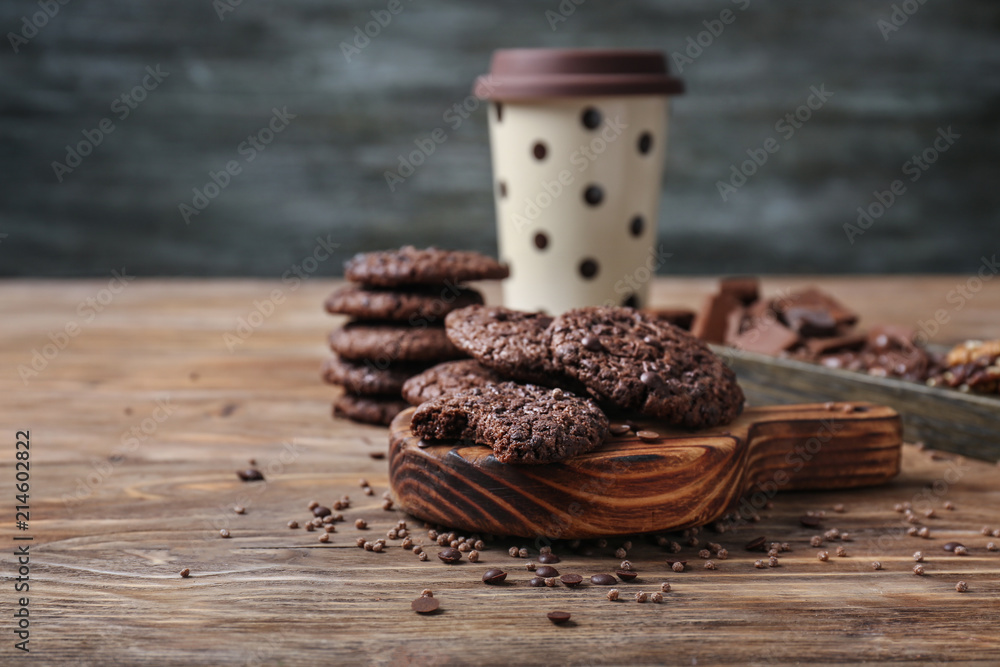 Board with delicious cookies on wooden table