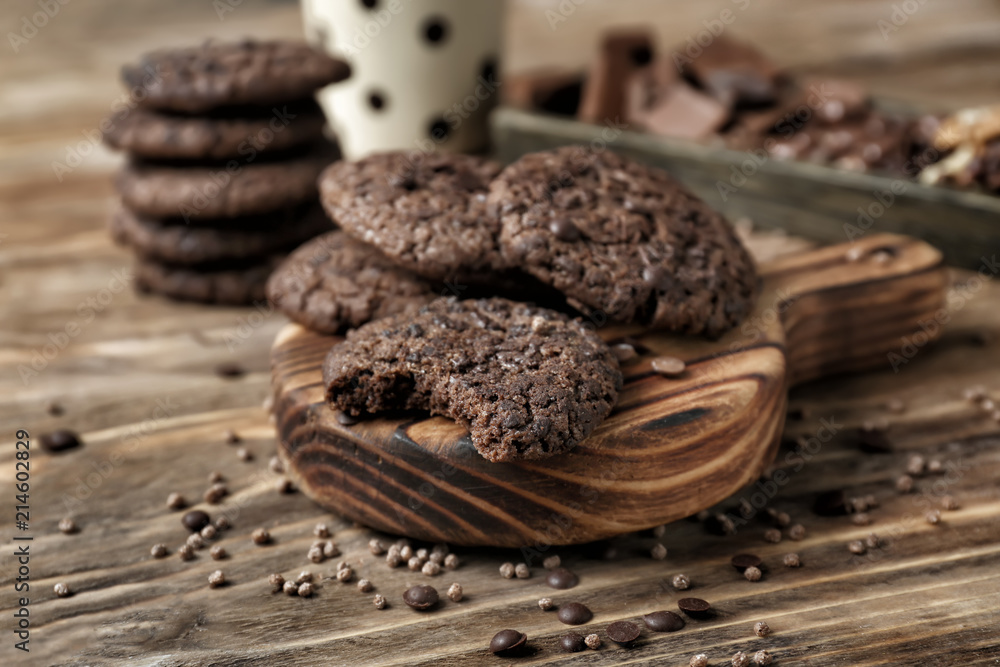 Board with delicious cookies on wooden background