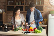 © Prostock-studio - Happy couple cooking healthy food together