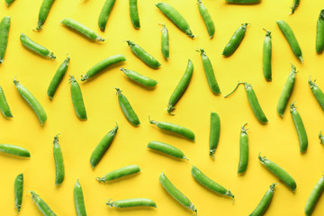 Pods of fresh green pea on color background