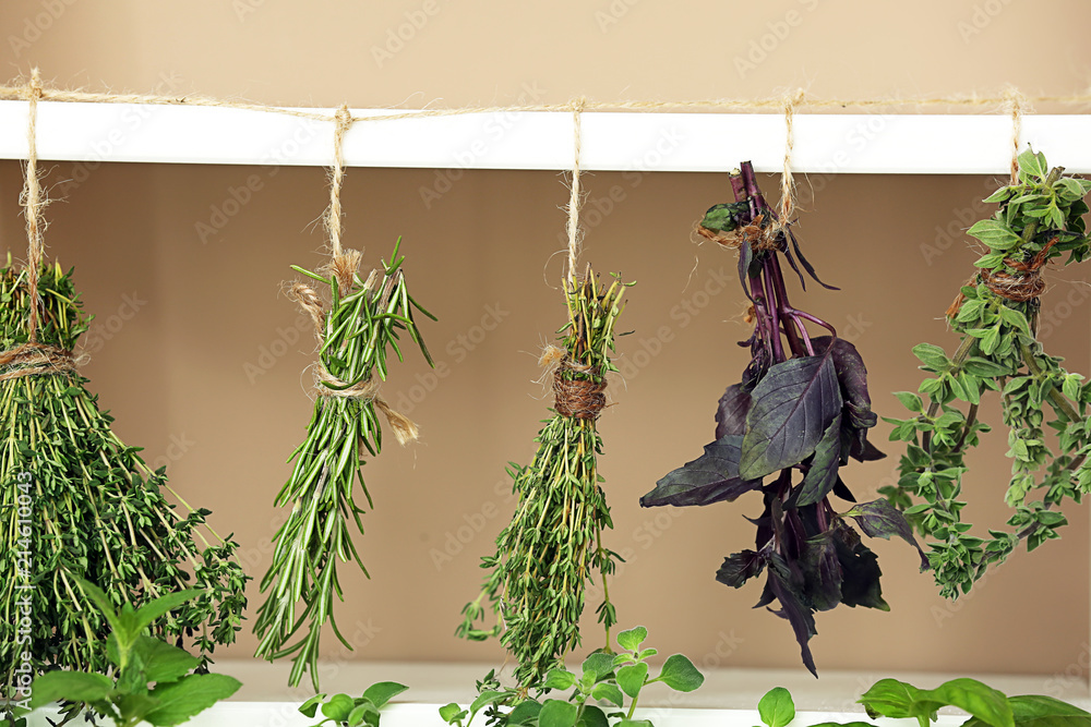 Bunches of fresh herbs hanging on string