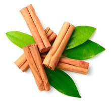 Cinnamon Sticks And Fresh Cinnamon Leaves Isolated On The White Background, Top View