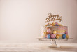 © Pixel-Shot - Stand with delicious birthday cake on table against light background