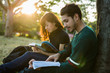 © torwaiphoto - Student was reading in the outdoors and good weather. And they're happy.lens flare