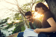 © torwaiphoto - Student was reading in the outdoors and good weather. And they're happy.lens flare