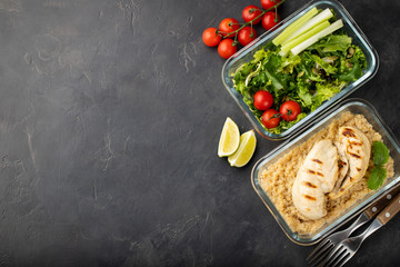 Healthy meal prep containers with quinoa, chicken breast and green salad overhead shot with copy space. Top view. Flat lay