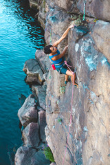 Wall Mural - A climber above the water.