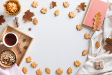 Top View And Flat Lay Of Autumn Composition Background. Notebook, Cup Of Hot Tea, Book, Autumn Leaves And Flowers, Cinnamon Cookies On White Background.