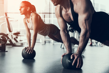 Young Man and Woman Training in Fitness Club.