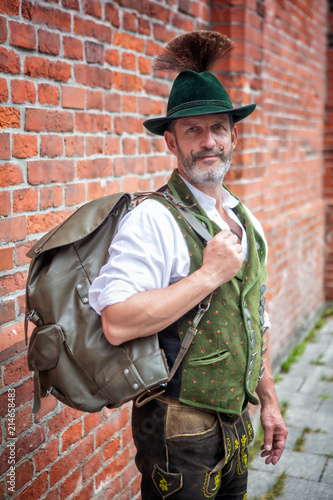 Fotografie, Obraz bavarian man standing outside with backpack