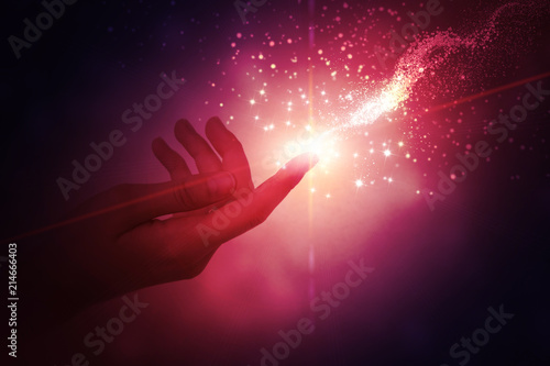 Cuadros en Lienzo A female hand giving a stream of magical energy on a dark abstract background