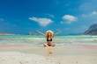 © Masson - Young redhead girl in black bikini and with hat on Balos beach, west Crete, Greece. Summertime season vacation, July