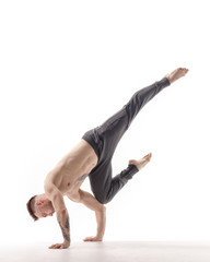 Young beautiful dancer is posing in studio