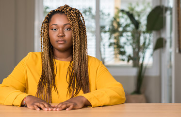 Sticker - African american woman at home with a confident expression on smart face thinking serious