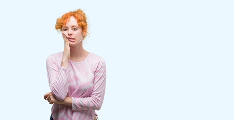 Wall Mural - Young redhead woman thinking looking tired and bored with depression problems with crossed arms.