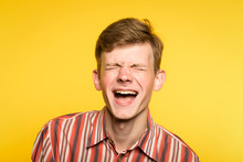 Lol Lmfao. Man Laughing Hard. Joy Happiness Humor And Wide Cheerful Smile Concept. Portrait Of A Young Guy On Yellow Background. Emotion Facial Expression And Feelings.