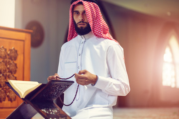 Wall Mural - Religious muslim man praying inside the mosque